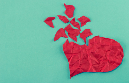 close up of paper broken heart on blue backgroundの写真素材