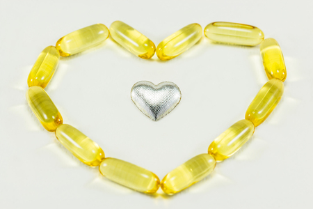 pills in heart shape and silver heartの写真素材