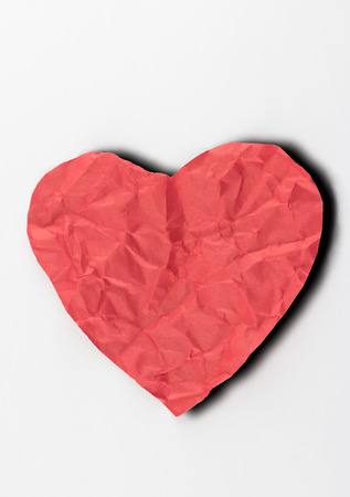 crumpled paper heart on white backgroundの写真素材