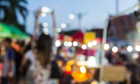 abstract blur background of people shopping at market fair and the woman put her hand up photograph the fairの写真素材
