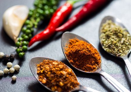three type of spices and herb on black stone background,selective focus