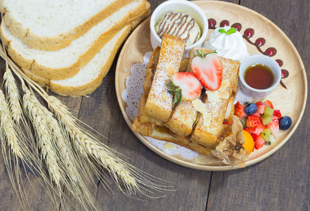 selective focus of honey toast on wood background with fruit and icecreamの写真素材