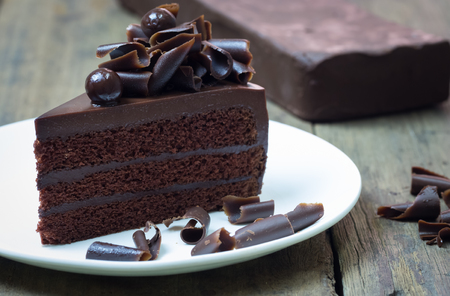 chocolate cake topping with chocolate curl on wood backgroundの写真素材