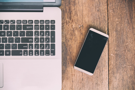 Business accessory. Laptop and smart phone for working business project on wooden table. You can apply for background,backdrop,wallpaper including website decor and artwork design.の写真素材