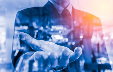 Double exposure of business man and the city on his habd.の写真素材