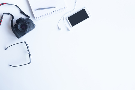 White desk office with laptop, smartphone and other work supplies with cup of coffee. Top view with copy space for input the text. Designer workspace on desk table essential elements on flat lay.の写真素材
