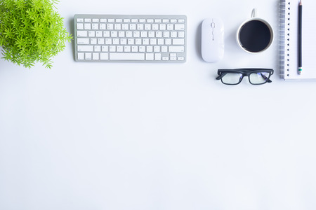 White desk office with laptop, smartphone and other work supplies with cup of coffee. Top view with copy space for input the text. Designer workspace on desk table essential elements on flat lay.の写真素材
