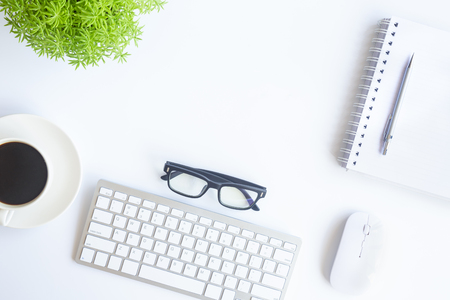 White desk office with laptop, smartphone and other work supplies with cup of coffee. Top view with copy space for input the text. Designer workspace on desk table essential elements on flat lay.の写真素材