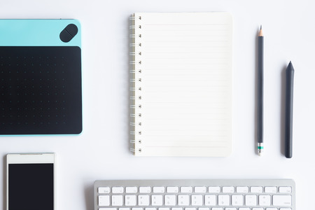 White desk office with laptop, smartphone and other work supplies with cup of coffee. Top view with copy space for input the text. Designer workspace on desk table essential elements on flat lay.の写真素材