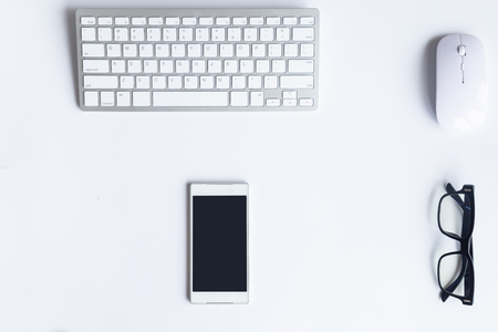 White desk office with laptop, smartphone and other work supplies with cup of coffee. Top view with copy space for input the text. Designer workspace on desk table essential elements on flat lay.の写真素材