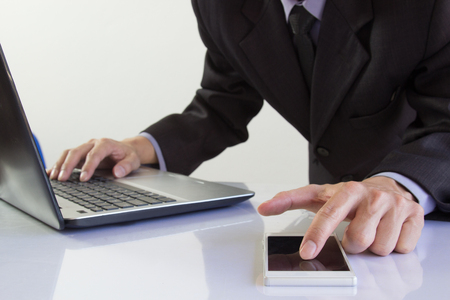 Businessman or accountant working on calculator to calculate business data concept. Accounting,investment advisor consulting situation on the financial report and planning a marketing plan at office.の写真素材