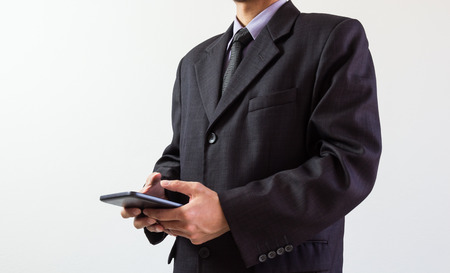 Businessman or accountant working on calculator to calculate business data concept. Accounting,investment advisor consulting situation on the financial report and planning a marketing plan at office.の写真素材