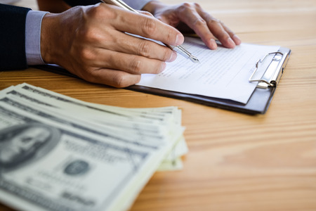 Business man signing a contract. Owns the business sign personally,director of the company, solicitor. Real estate agent holding house, moving home or renting property, merger and acquisition concept.の写真素材
