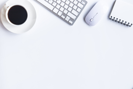 White desk office with laptop, smartphone and other work supplies with cup of coffee. Top view with copy space for input the text. Designer workspace on desk table essential elements on flat lay.の写真素材