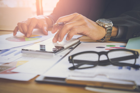 Businessman or accountant working on calculator to calculate business data concept....