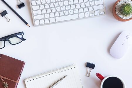 White desk office with laptop, smartphone and other work supplies with cup of coffee. Top view with copy space for input the text. Designer workspace on desk table essential elements on flat lay.の写真素材