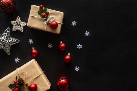 Holiday Christmas card background with festive decoration ball, stars, snowflakes, gift box, pine cones on a black background from Flat lay, top view. Space for text Merry Christmas and happy New Yearの写真素材