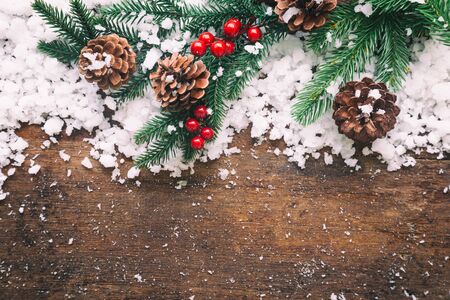 Holiday Christmas card background with festive decoration ball, stars, snowflakes, gift box, pine cones on a wood background from Flat lay, top view. Space for text Merry Christmas and happy New Yearの写真素材
