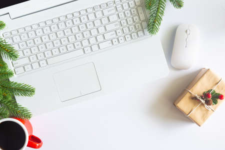 White Christmas, desk office with laptop, decoration and work supplies with cup of coffee. Top view with copy space for input the text. Flat lay desk table winter Christmas. Business Holidays Concept.の写真素材