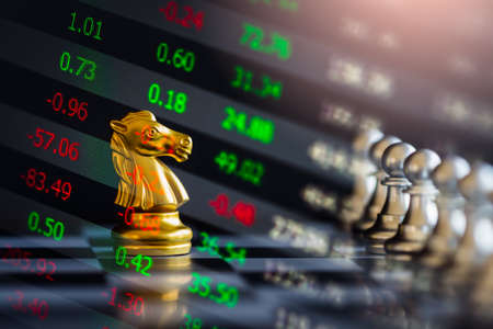 Chess game on chess board behind business man background. Business concept to present financial information and marketing strategy analysis. Investment target in global economy and digital commercial.の写真素材