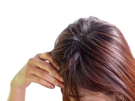 Young woman Serious and Stressed effected to headache and gray hair on white backgroundの写真素材