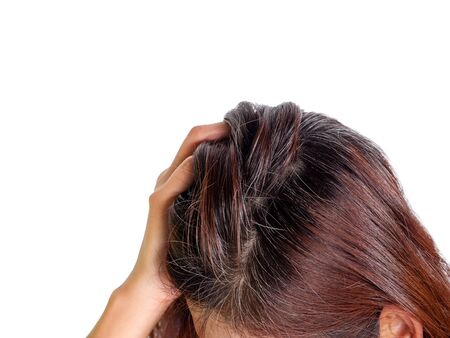 Young woman Serious and Stressed effected to headache and gray hair on white backgroundの写真素材
