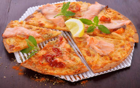 Pizza smoked salmon and lemon on woodenの写真素材