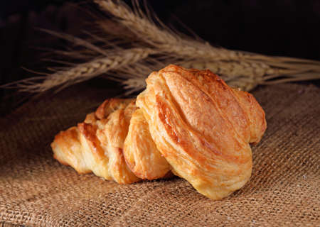 fresh croissant on wooden background