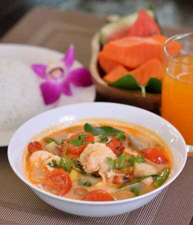 Tom Yum soup in a white bowlの写真素材