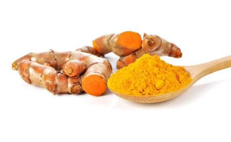 Turmeric powder and turmeric isolated on white background.の写真素材