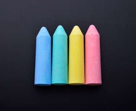 Colored chalk on a dark school board. The concept of children's creativity games, back to school....