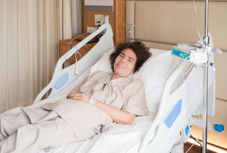 asian elderly patient lying on bed in hospitalの写真素材