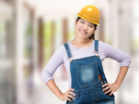 asian engineering woman wearing safety helmet and jumpsuitの写真素材