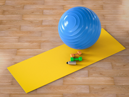 3d rendering fitness ball and dumbbells on yoga matの写真素材