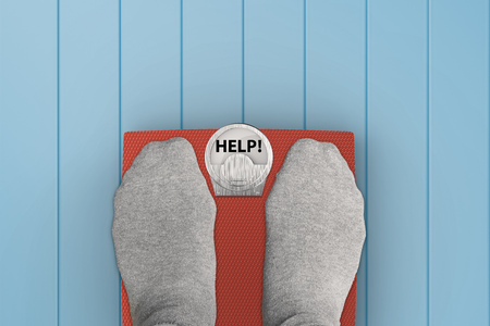 foot standing on weight scales with text "help"の写真素材
