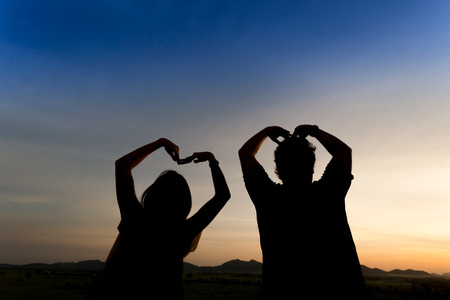 silhouette happy couple with twilight sky backgroundの写真素材
