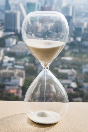 hourglass or sandglass with cityscape background