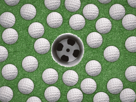 top view golf balls with empty golf cup on green backgroundの写真素材