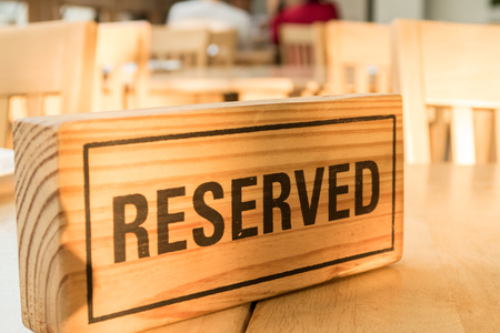 wooden reserved sign on tableの写真素材