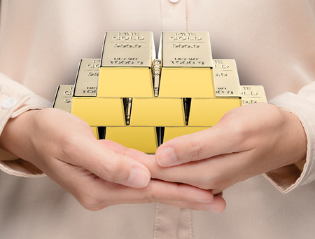 hand holding 3d rendering heap of bullionの写真素材
