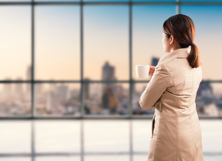 rear view of businesswoman standing with cityscape backgroundの写真素材