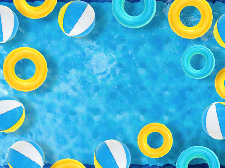 beach balls and swim rings floating on pool top view with blank spaceの写真素材