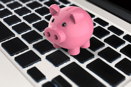 3d rendering piggy bank on keyboardの写真素材