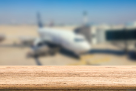 empty wooden table with airplane blurred backgroundの写真素材