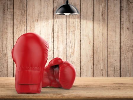 3d rendering red boxing gloves on wooden backgroundの写真素材