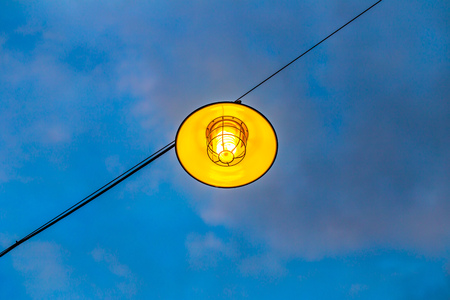 pendant lamp hanging outdoor with cloudy blue sky backgroundの写真素材