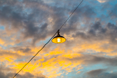 pendant lamp hanging outdoor with cloudy blue sky backgroundの写真素材