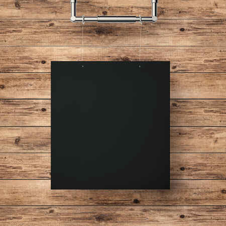 black blank frame hanging on timber wall backgroundの写真素材