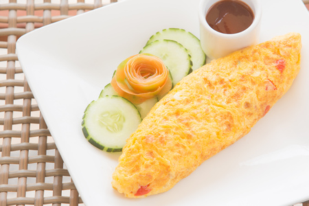 omelette on white dish serving with ketchupの写真素材