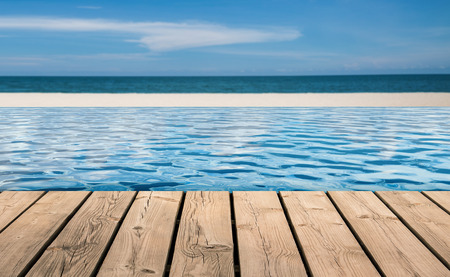 wooden floor with infinity pool on beach backgroundの写真素材